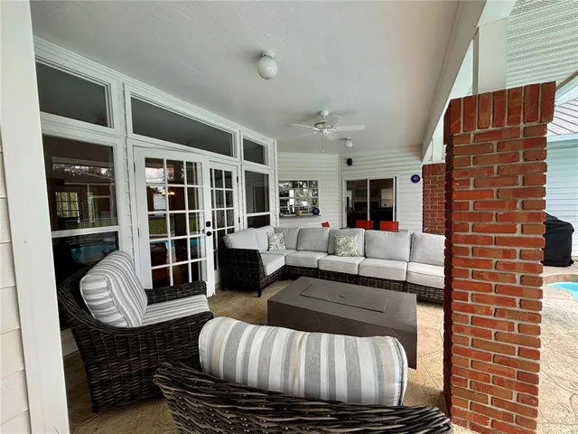 a swimming pool with outdoor seating and yard