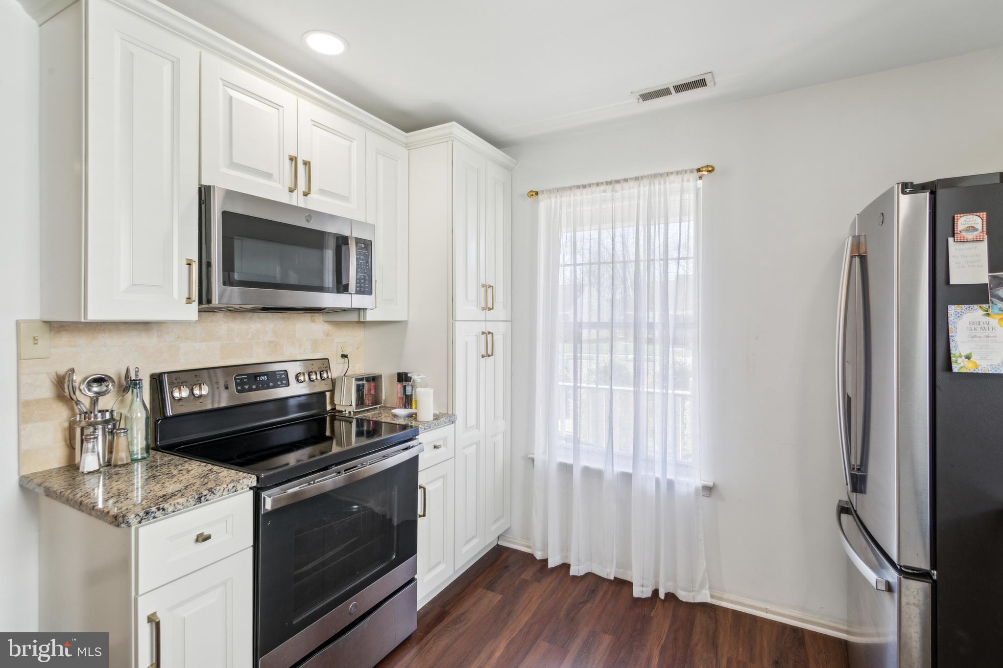 48 Eddystone Way Mount Laurel, NJ 08054 - Photo 6 of 30 a kitchen with stainless steel appliances granite countertop a stove a refrigerator and a microwave