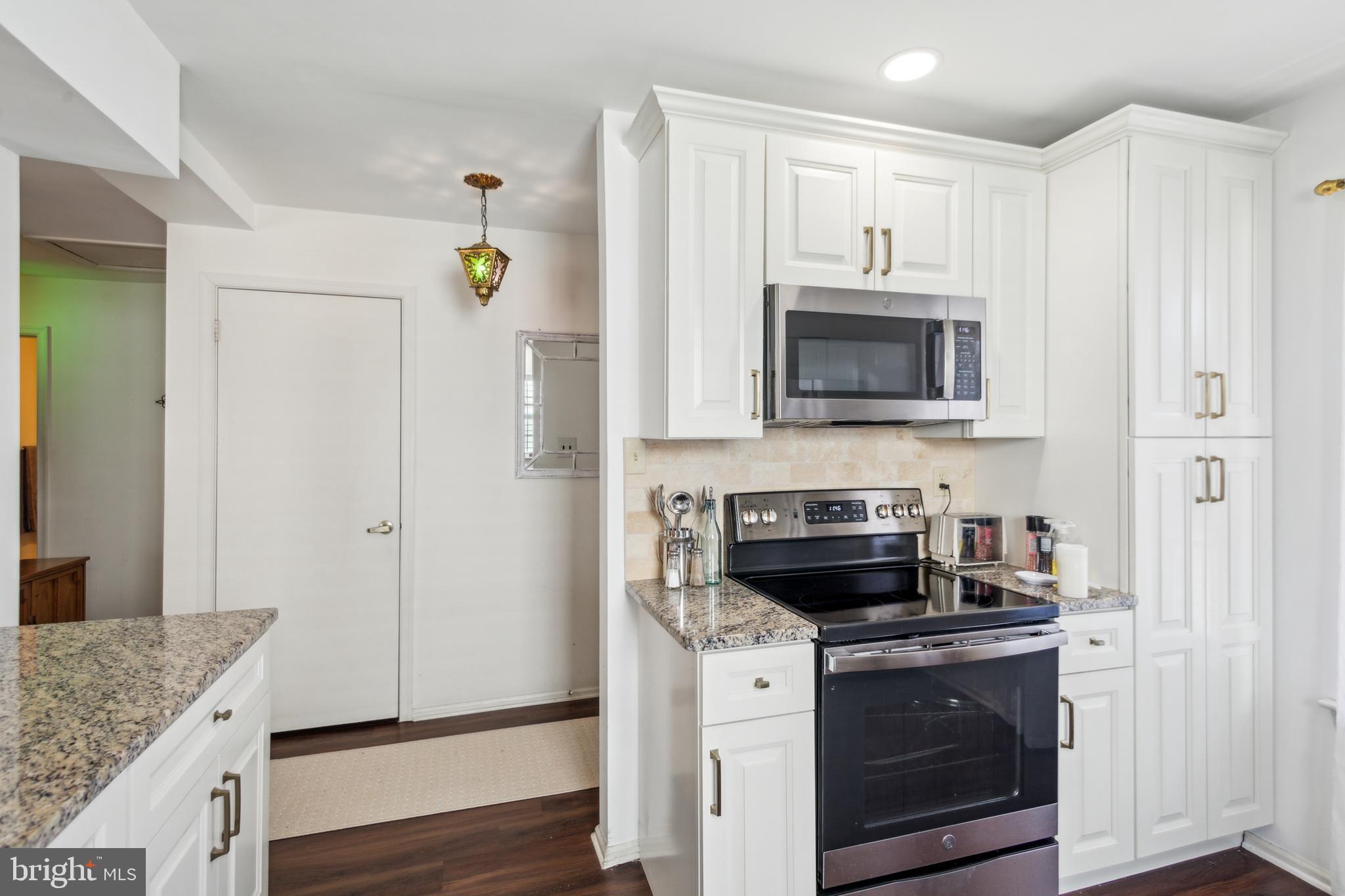 48 Eddystone Way Mount Laurel, NJ 08054 - Photo 7 of 30 a kitchen with granite countertop a stove and a microwave