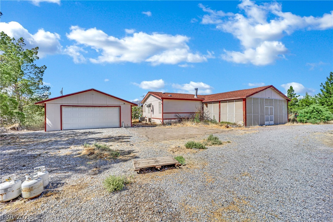 4361 Maple Road Pahrump, NV 89048 - Photo 3 of 46 A spacious gravel lot provides ample parking, with a detached garage and additional structures offering versatile usage.