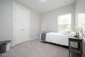 a bed room with a bed and a window