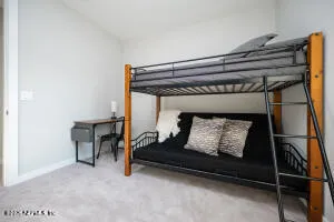 a bed sitting in a room next to a window
