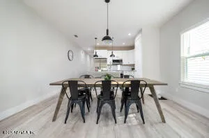 a view of a dining room with furniture window and wooden floor