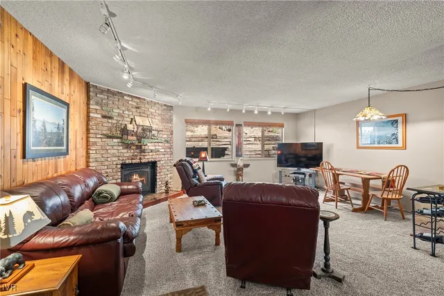 a living room with furniture a large window and a flat screen tv
