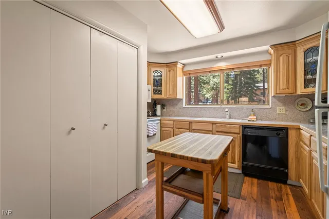 a kitchen with a wooden floor and a table
