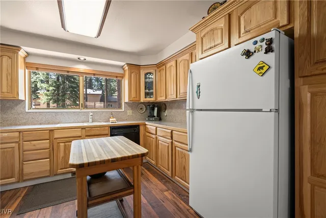 a kitchen with a refrigerator a stove and a window