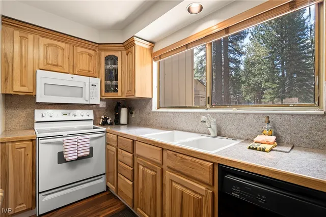 a kitchen with a sink stove and microwave