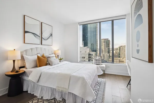 a bedroom with a large bed and a large window
