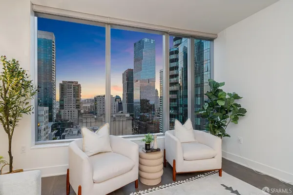 a living room with furniture and a potted plant