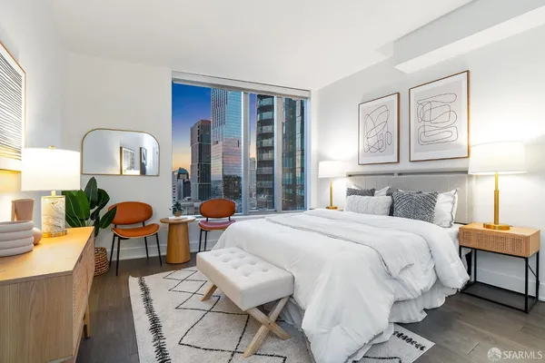 a bedroom with bed and wooden floor