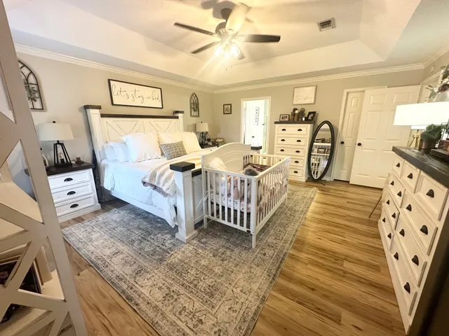 a bedroom with furniture and a wooden floor