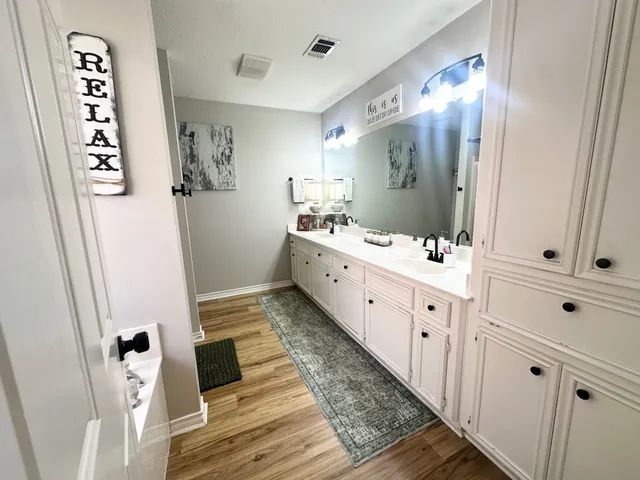 a bathroom with a double vanity sink and mirror