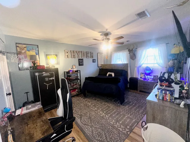 a living room with furniture a flat screen tv and a window