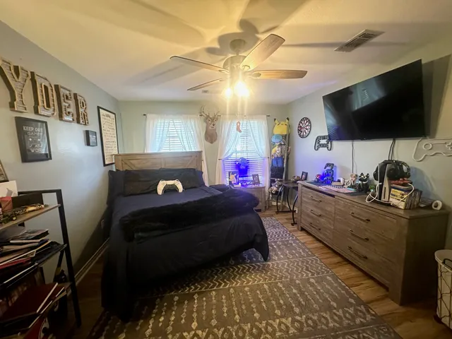 a bed room with a bed tv and a mirror