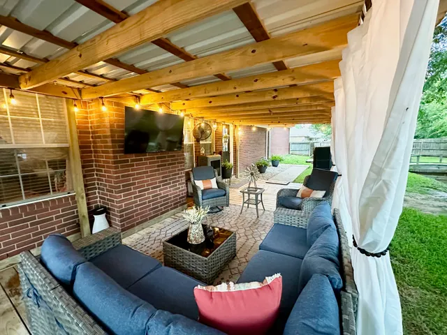 a view of a patio with couches chairs and a potted plant