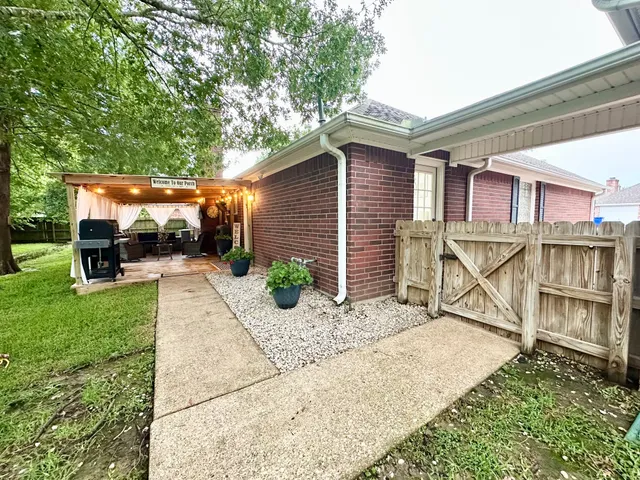 a backyard of a house with lots of green space and fountain
