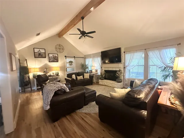 a living room with furniture fireplace and a flat screen tv