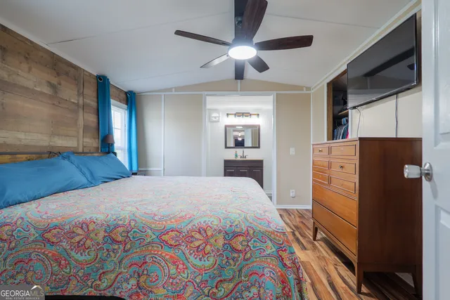 a bedroom with a bed and a flat screen tv