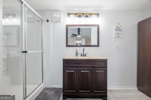 a bathroom with a sink a mirror and a shower