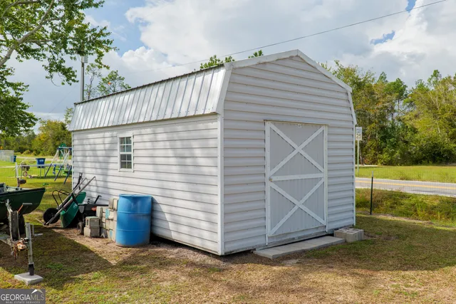 a view of a house with backyard and sitting area