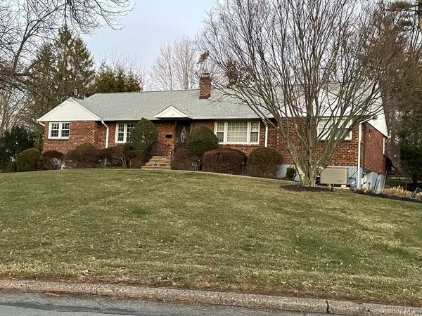 a front view of house with yard and trees
