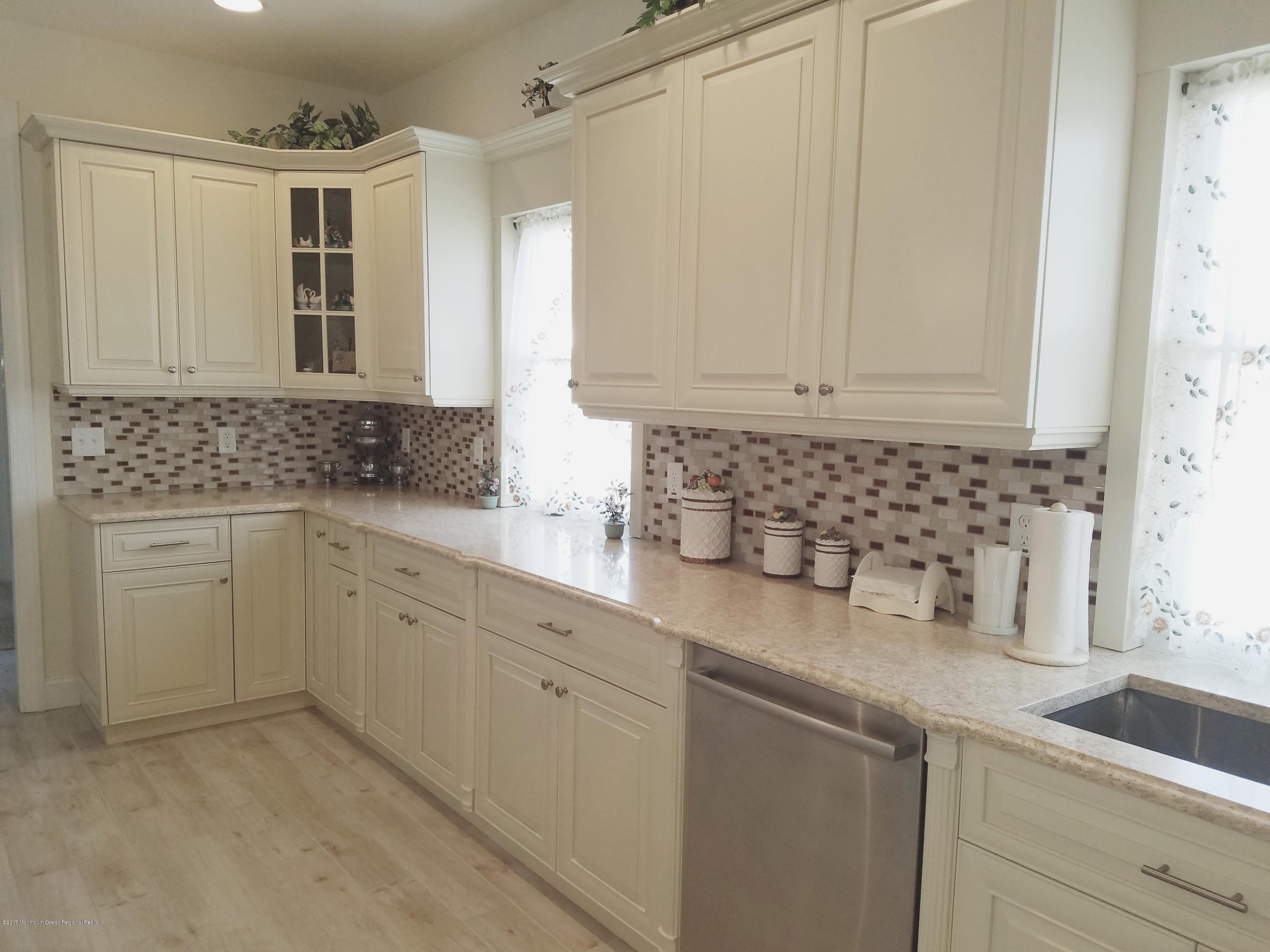 12 Cindy Court Howell, NJ 07731 - Photo 12 of 64 a kitchen with sink cabinets and window