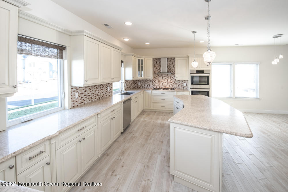 12 Cindy Court Howell, NJ 07731 - Photo 13 of 64 a large white kitchen with cabinets a sink a window and stainless steel appliances