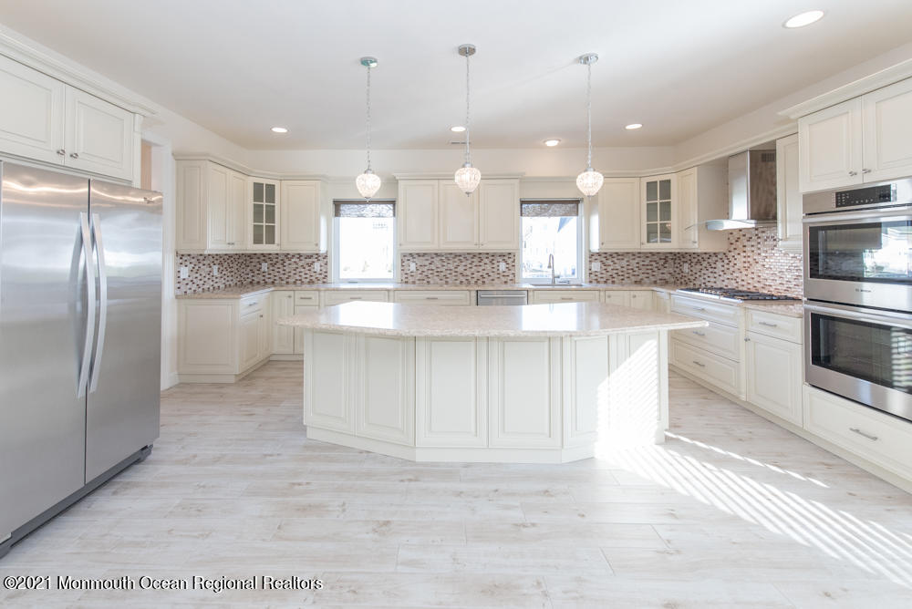 12 Cindy Court Howell, NJ 07731 - Photo 14 of 64 a large kitchen with stainless steel appliances kitchen island granite countertop a stove a sink a refrigerator and a microwave