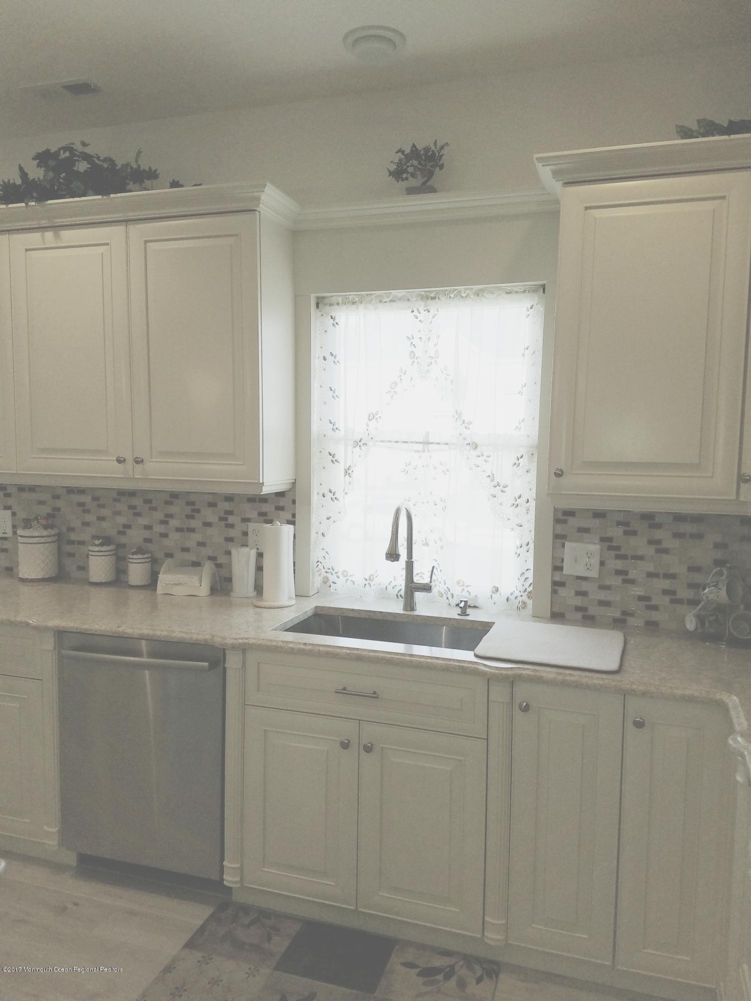 12 Cindy Court Howell, NJ 07731 - Photo 18 of 64 a kitchen with white cabinets white appliances and a sink