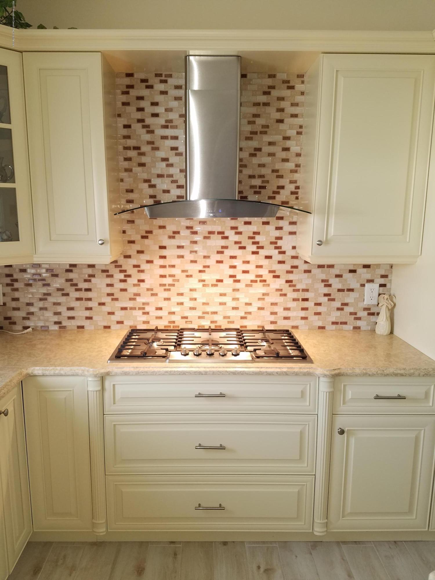 12 Cindy Court Howell, NJ 07731 - Photo 22 of 64 a view of granite countertop white cabinets and sink