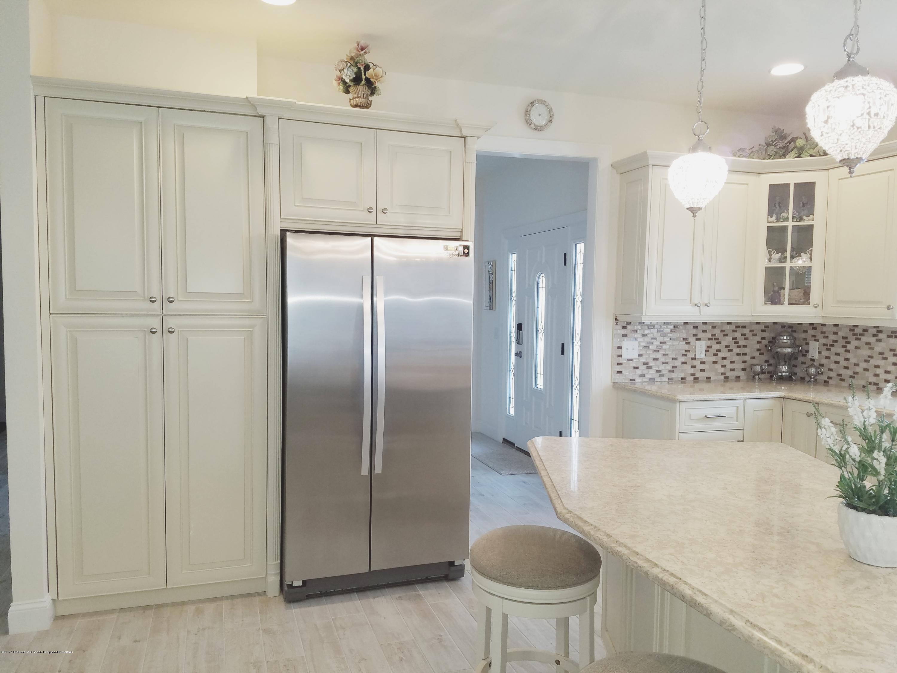 12 Cindy Court Howell, NJ 07731 - Photo 23 of 64 a spacious bathroom with a granite countertop sink and a mirror