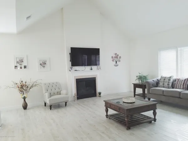 a view of a dining room with furniture and chandelier