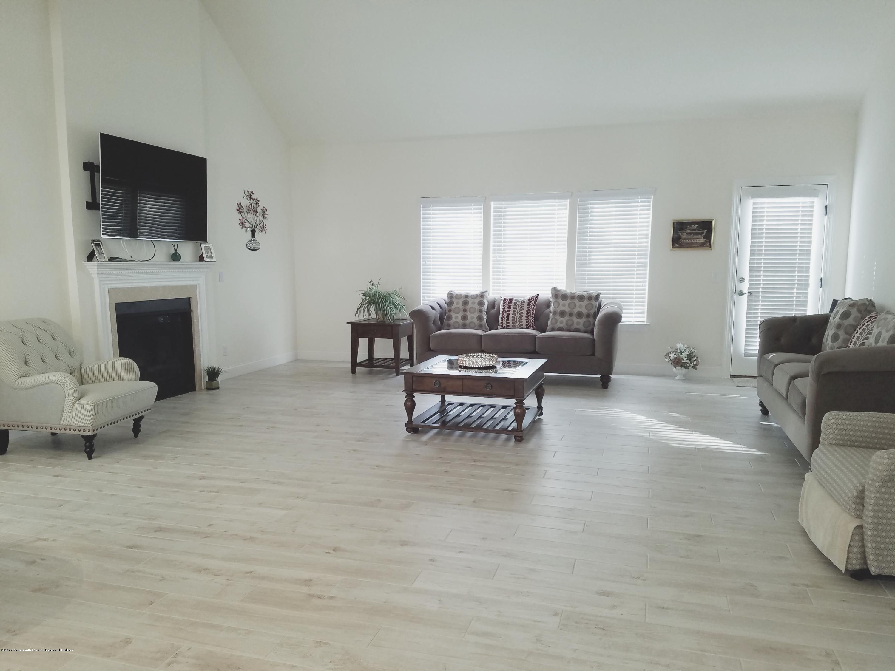12 Cindy Court Howell, NJ 07731 - Photo 26 of 64 a living room with furniture and a fireplace