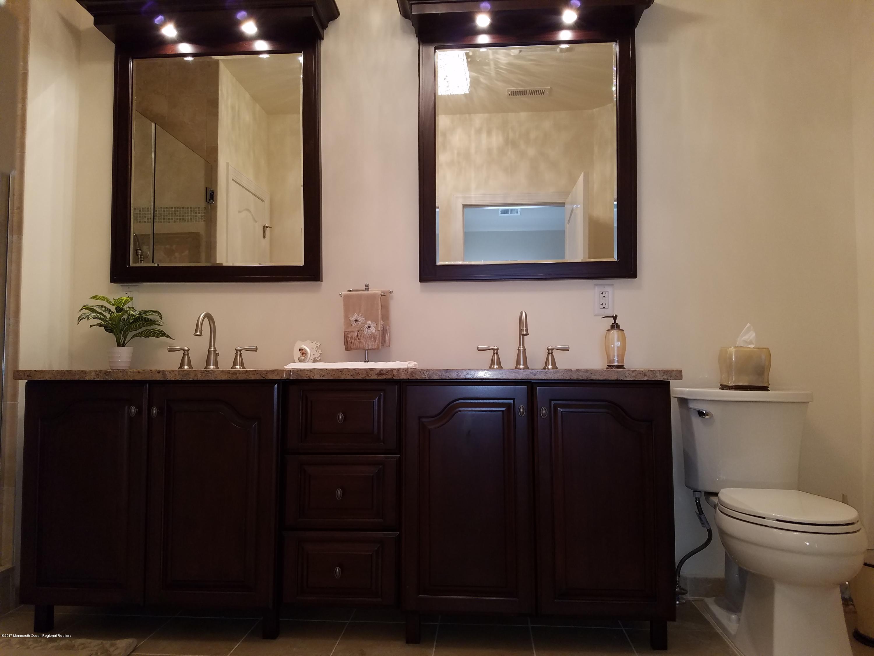 12 Cindy Court Howell, NJ 07731 - Photo 33 of 64 a bathroom with a double vanity sink and a mirror