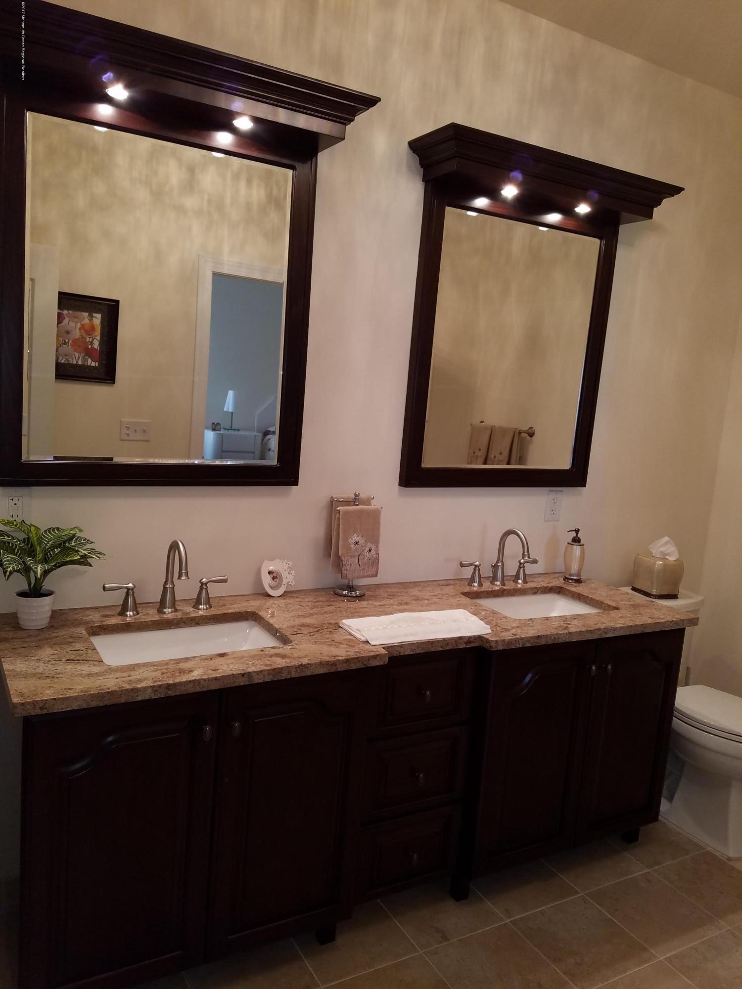 12 Cindy Court Howell, NJ 07731 - Photo 34 of 64 a bathroom with a double vanity sink and a mirror