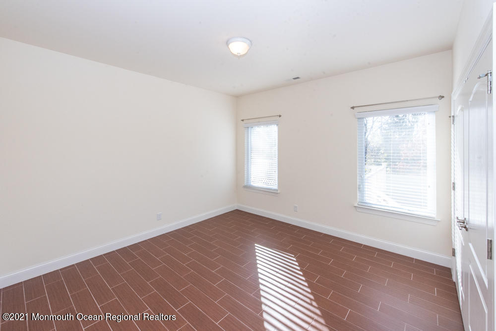 12 Cindy Court Howell, NJ 07731 - Photo 36 of 64 an empty room with wooden floor and windows