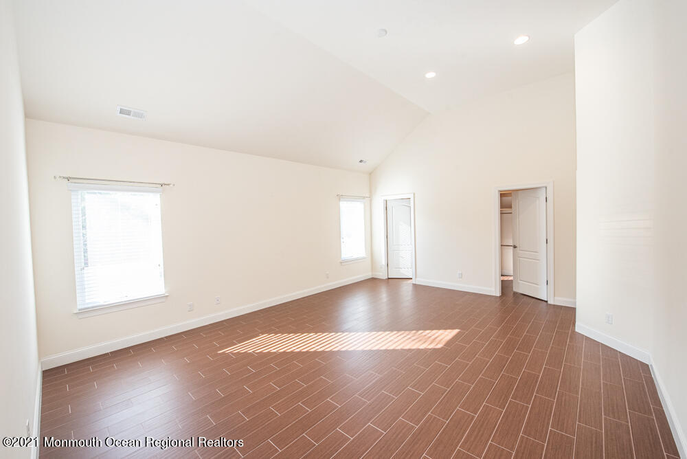 12 Cindy Court Howell, NJ 07731 - Photo 38 of 64 an empty room with wooden floor and windows