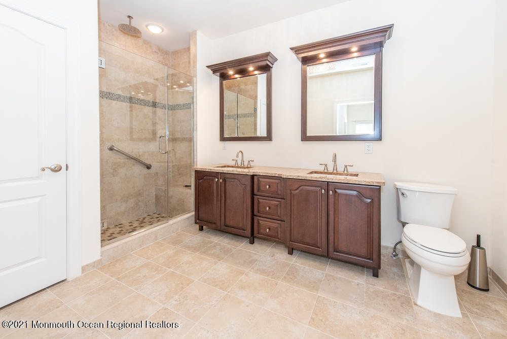 12 Cindy Court Howell, NJ 07731 - Photo 40 of 64 a bathroom with a toilet sink and mirror