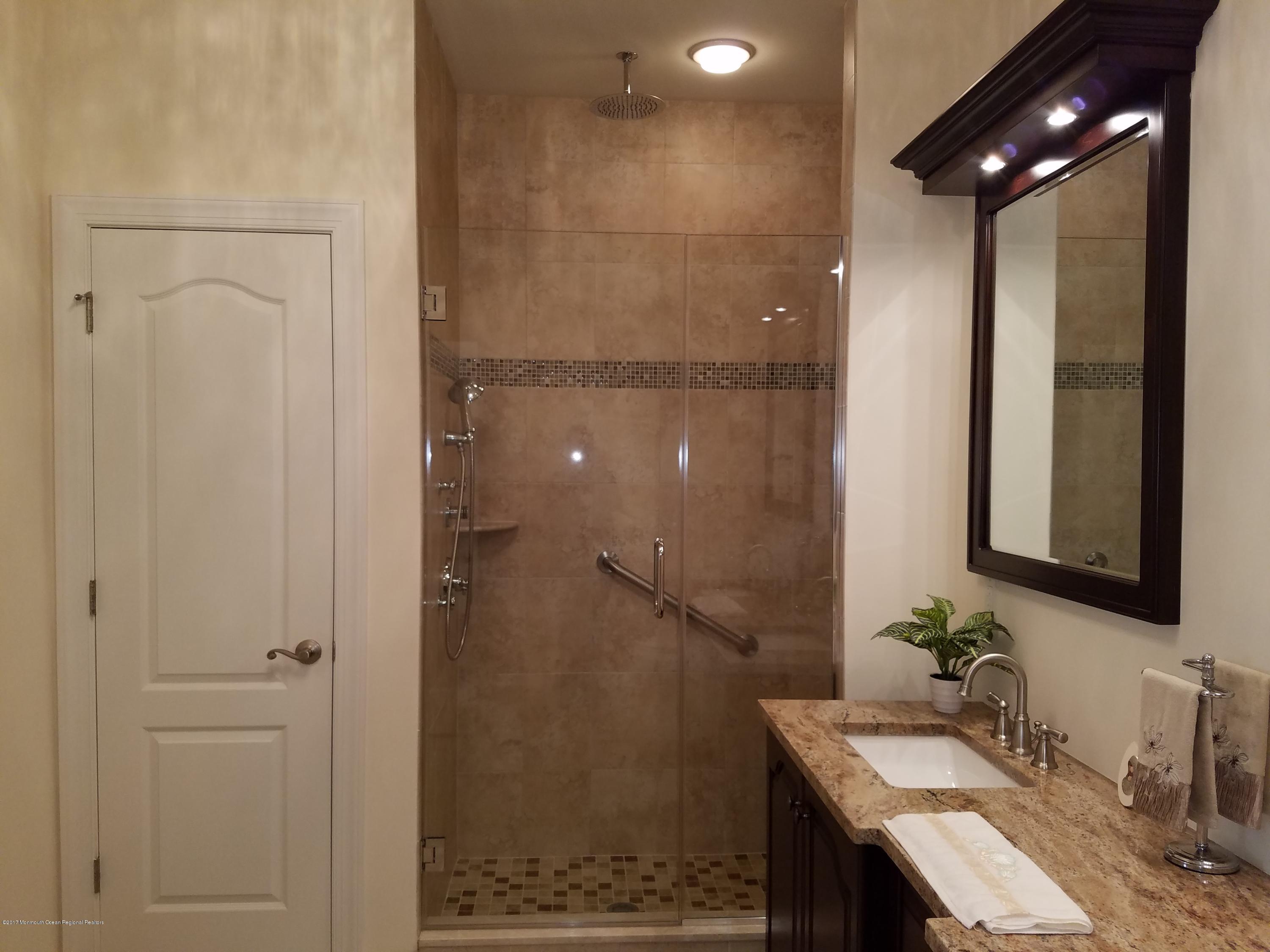 12 Cindy Court Howell, NJ 07731 - Photo 42 of 64 a bathroom with a sink and a mirror