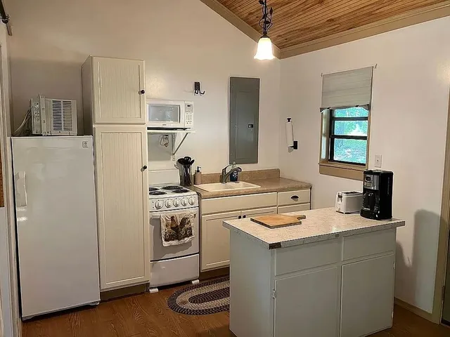 a kitchen with a sink stove and refrigerator
