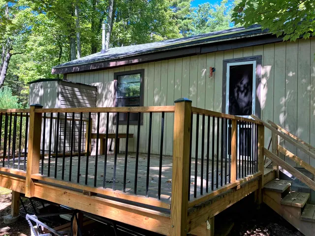 a view of a wooden house with a deck