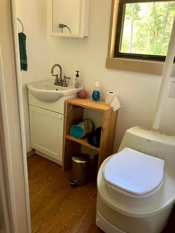 a bathroom with a sink toilet and mirror