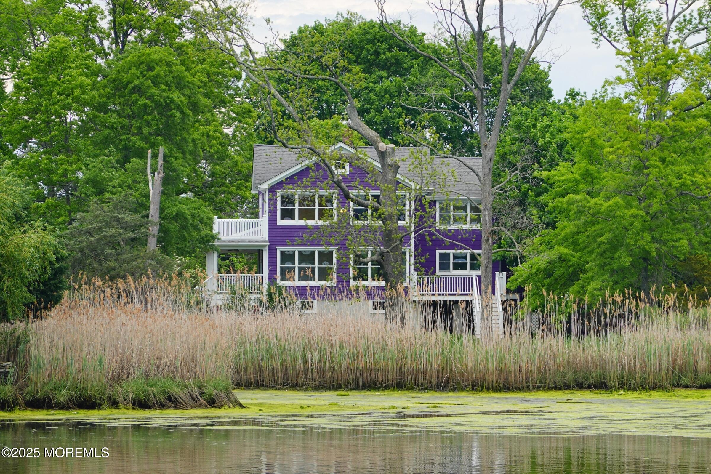 a front view of a house with a garden and plants