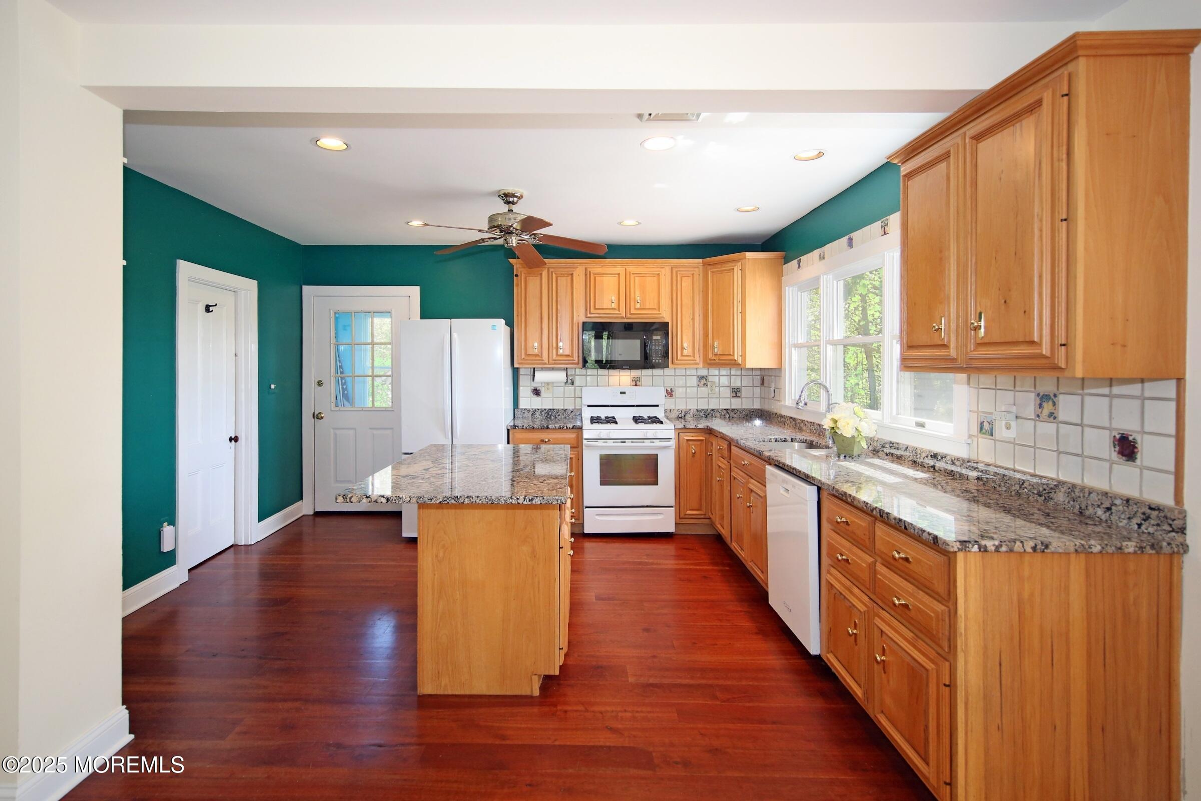 40 Riverside Avenue Oceanport, NJ 07757 - Photo 14 of 62 a large kitchen with stainless steel appliances granite countertop a stove a sink dishwasher and a refrigerator