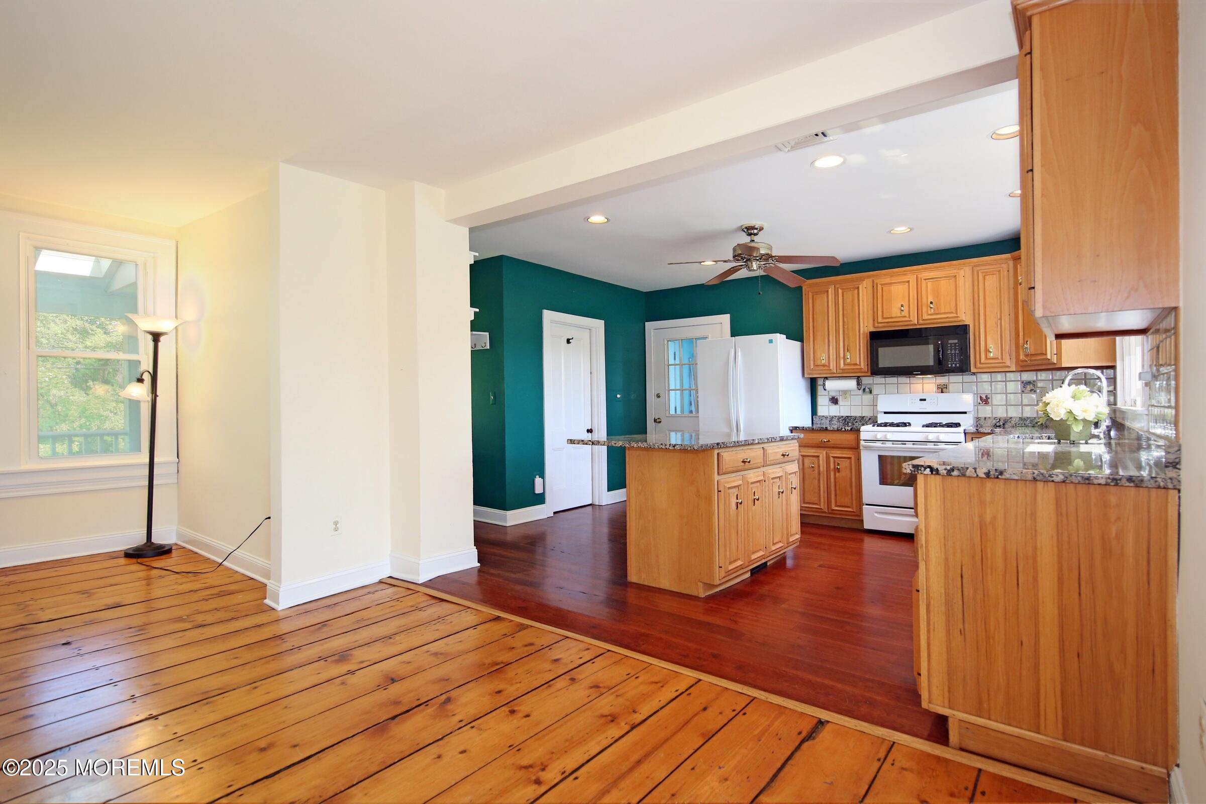 40 Riverside Avenue Oceanport, NJ 07757 - Photo 16 of 62 a view of kitchen with stainless steel appliances granite countertop a stove top oven a sink and white cabinets with wooden floor