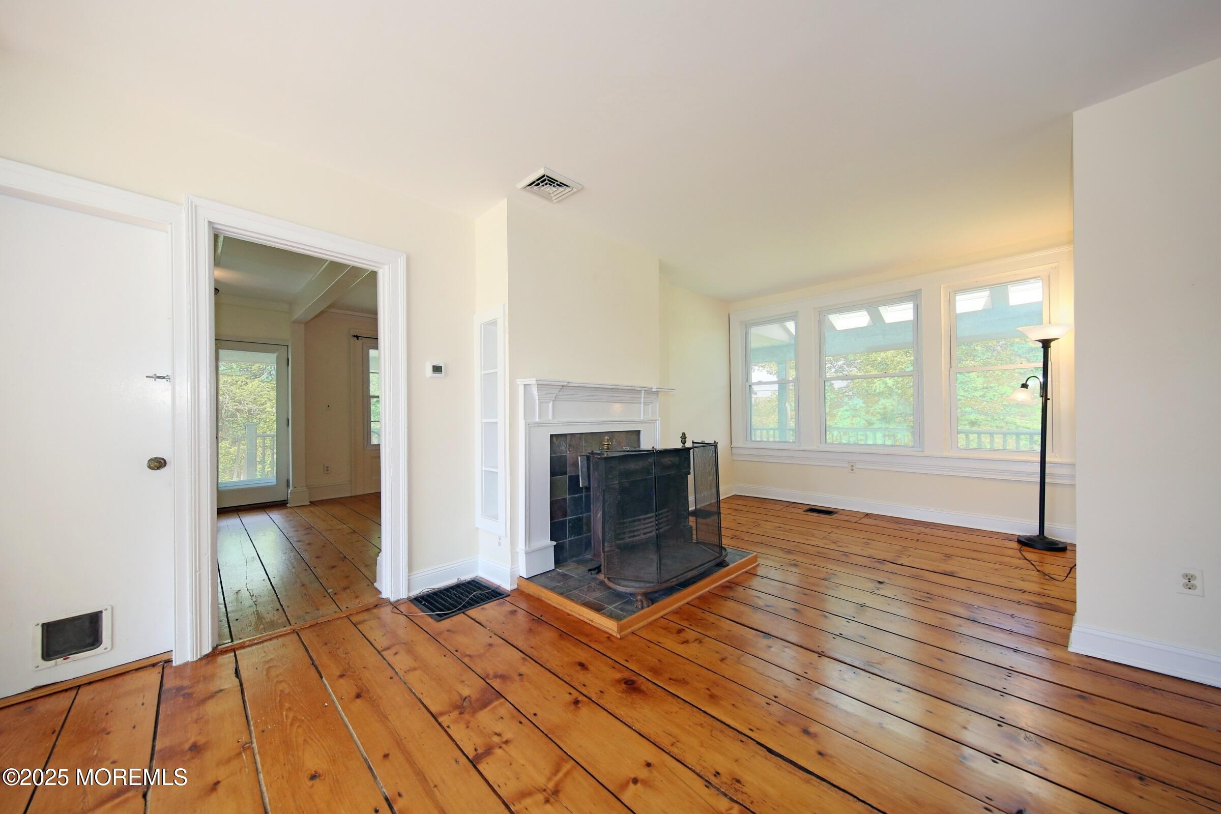 40 Riverside Avenue Oceanport, NJ 07757 - Photo 17 of 62 a bedroom with a bed and a fireplace