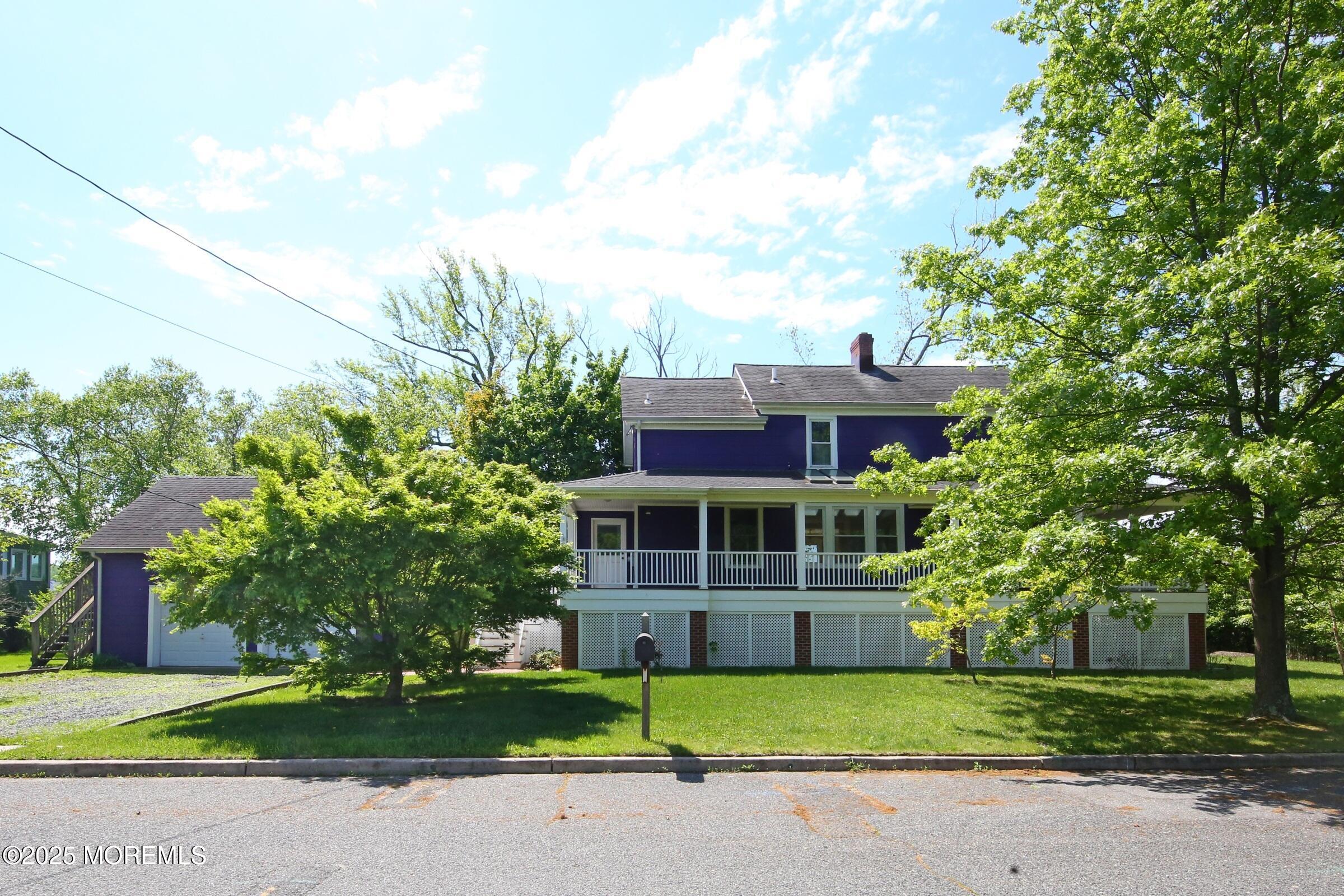 40 Riverside Avenue Oceanport, NJ 07757 - Photo 2 of 62 a front view of a house with a garden and trees