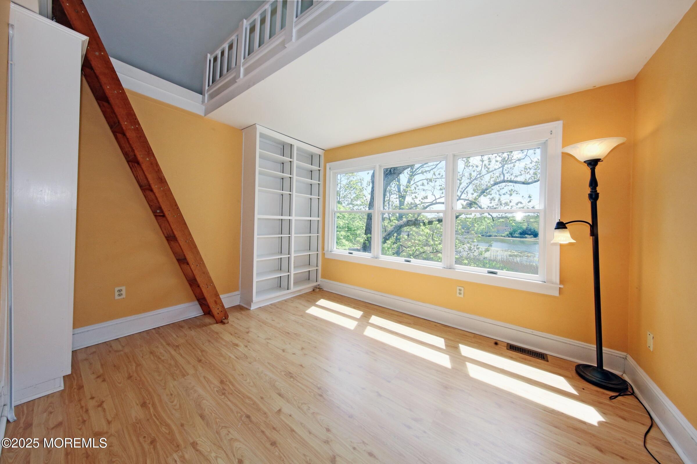 40 Riverside Avenue Oceanport, NJ 07757 - Photo 29 of 62 a view of an empty room with a window and wooden floor