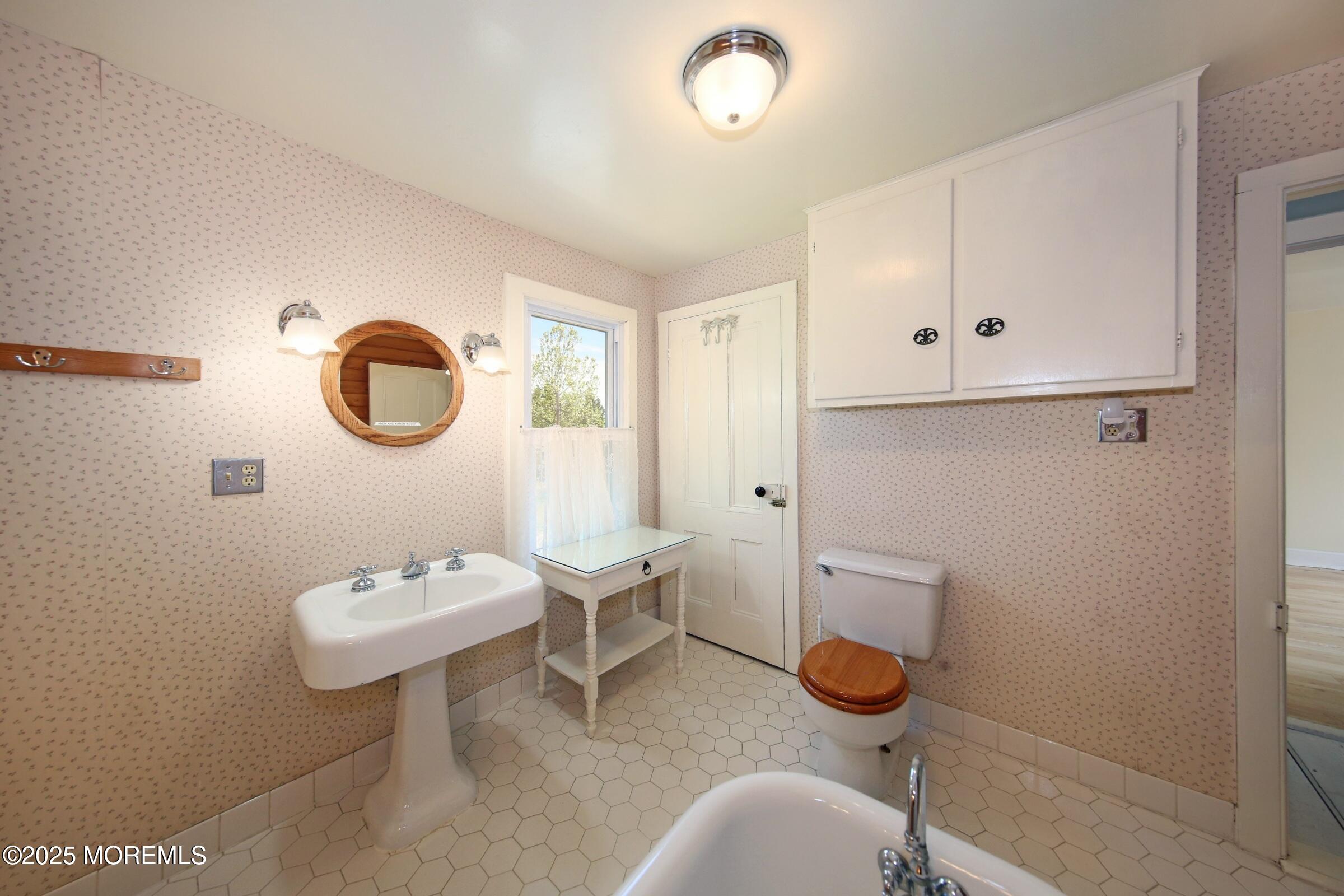 40 Riverside Avenue Oceanport, NJ 07757 - Photo 32 of 62 a bathroom with a granite countertop sink mirror and toilet