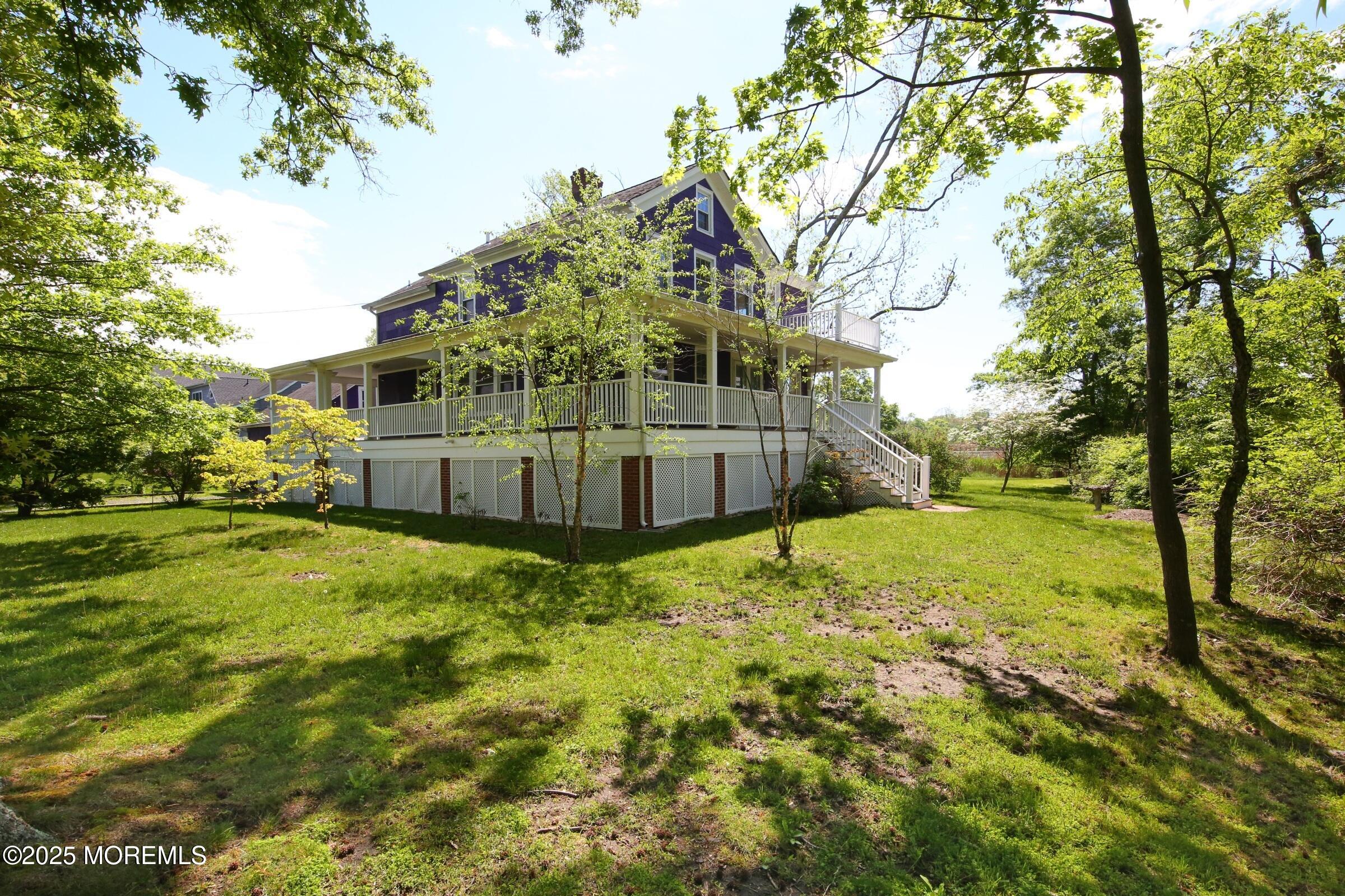 40 Riverside Avenue Oceanport, NJ 07757 - Photo 4 of 62 a view of a yard in front of a house with large trees